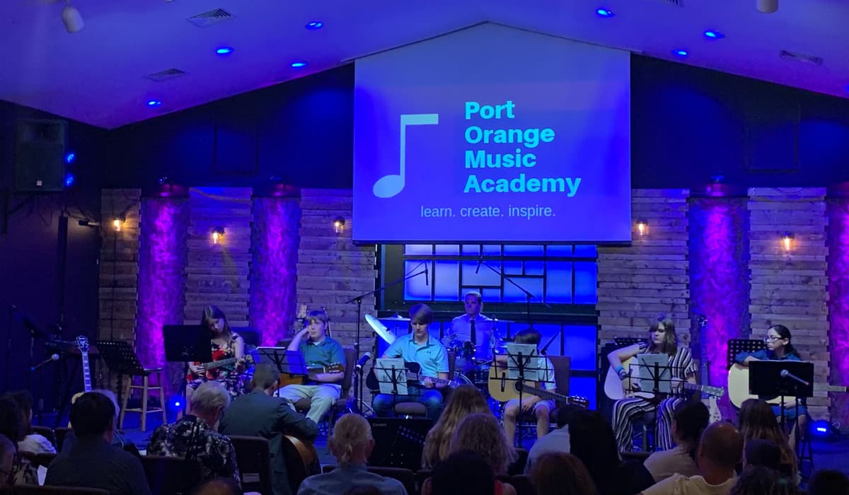 POMA students performing together on stage